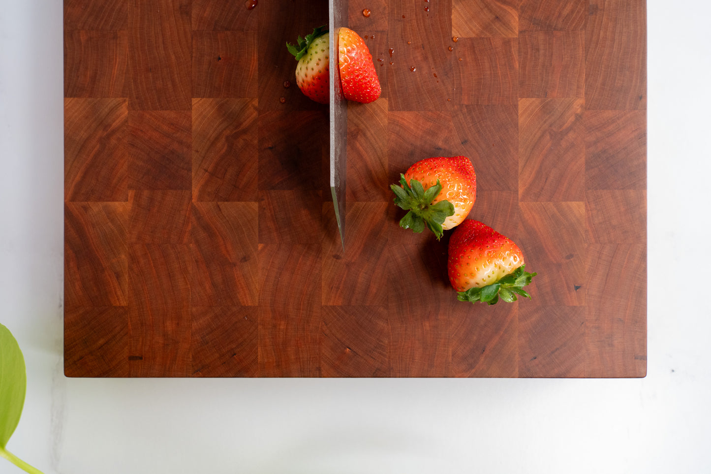 Cherry wood cutting board, end grain pattern, fresh cut strawberries