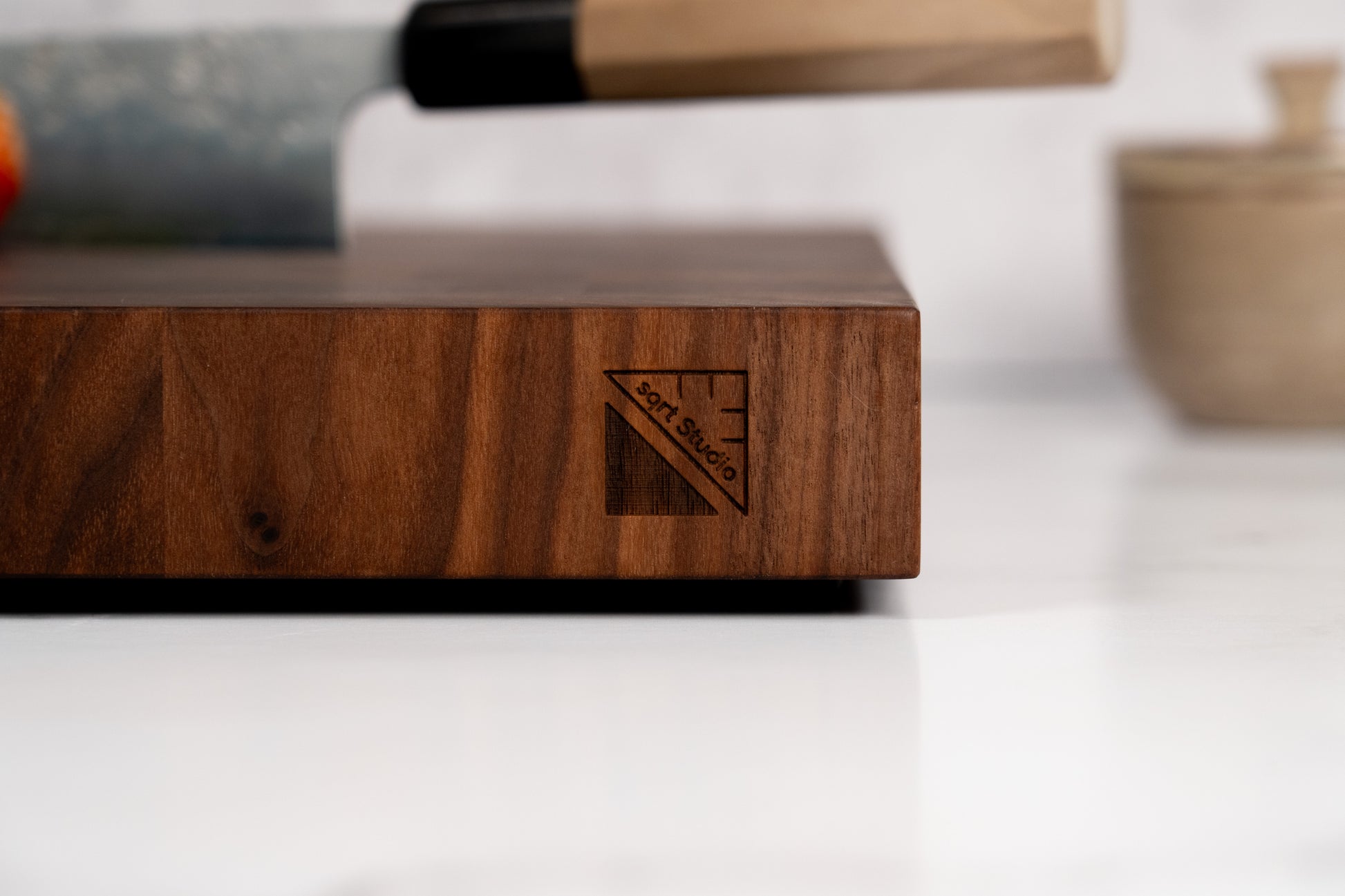 Black walnut cutting board with Square Root Studio logo engraved, laser engraving