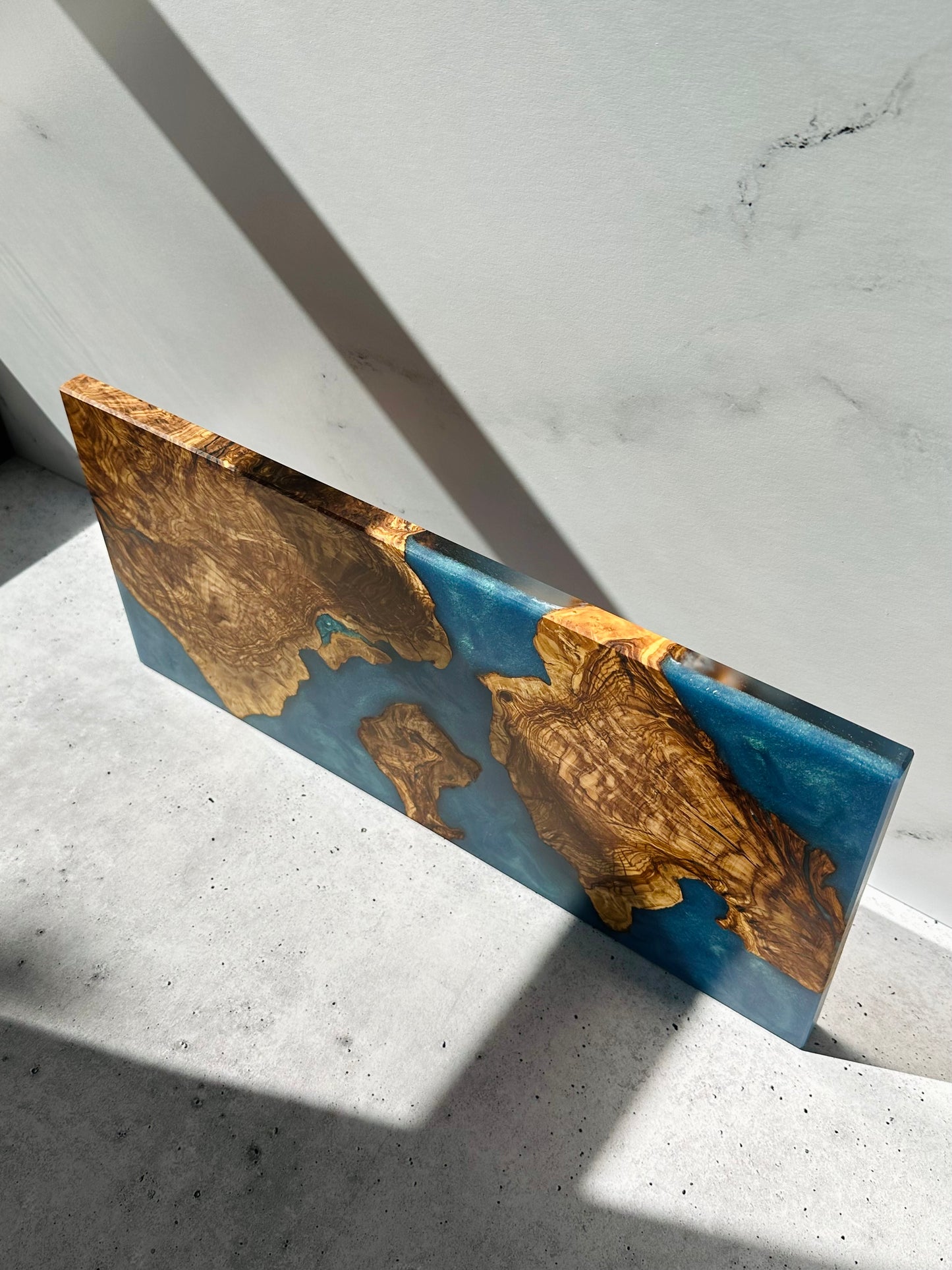 Olive wood cutting board blue ocean top view