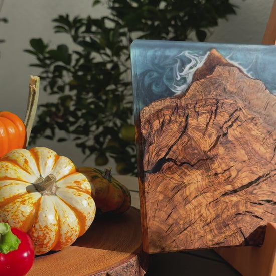 outdoors ocean blue olive wood charcuterie board presentation next to pumpkins vegetables