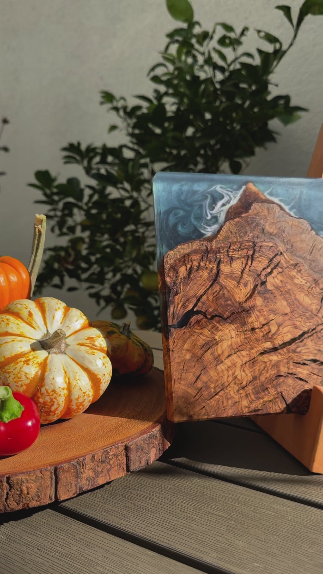 outdoors ocean blue olive wood charcuterie board presentation next to pumpkins vegetables