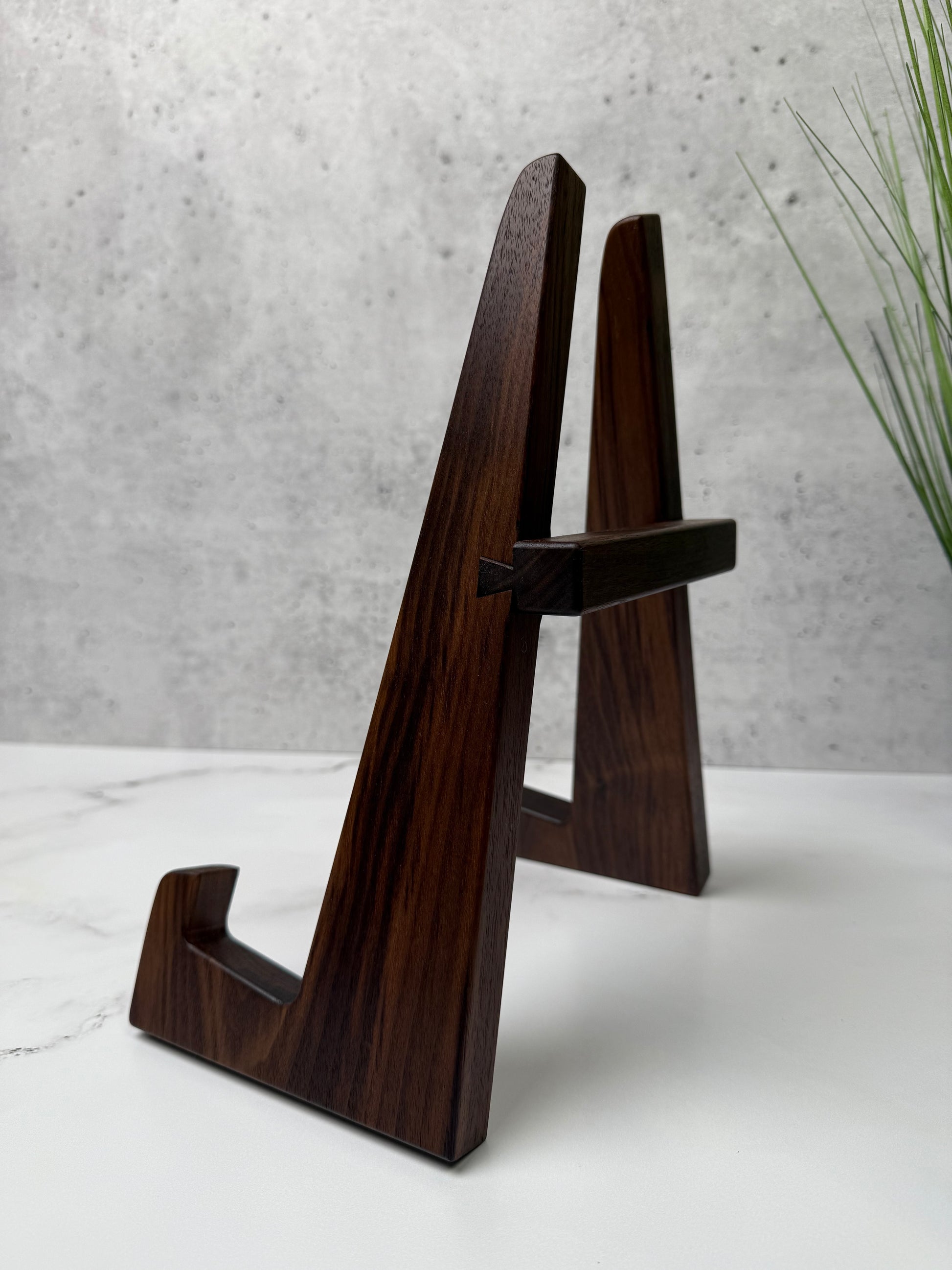Walnut cutting board stand that keeps your board vertically at a mild angle allowing for uniform drying and ventilation all around. Sturdy butcher block stand with adjustable width handmade in USA by Square Root Studio